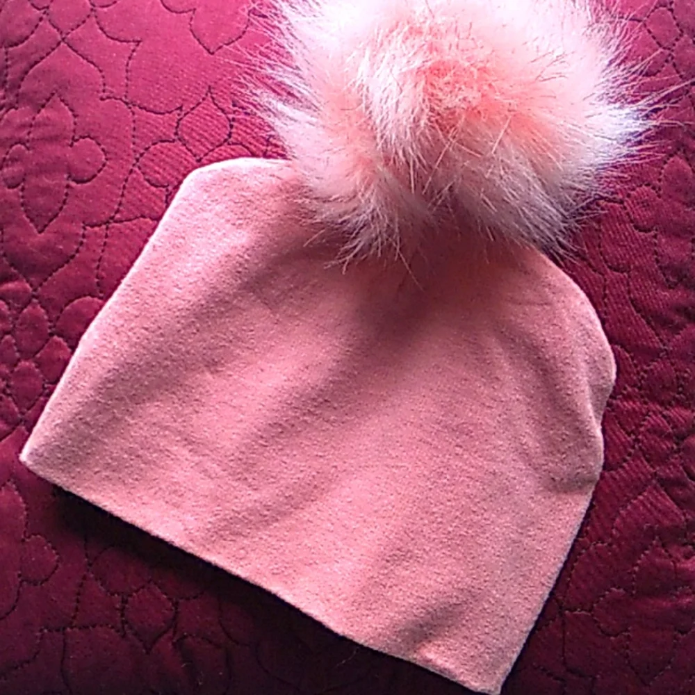 Pink hat with big fur pom pom